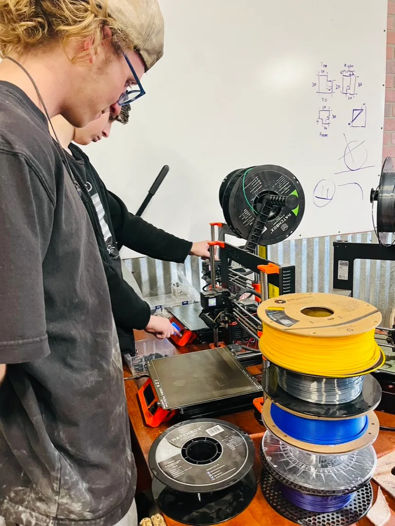 Student working with equipment in the CTA manufacturing lab